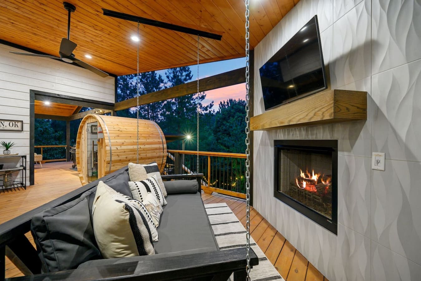 This deck is basically your personal cozy hangout spot where you can literally watch the fire flicker while lounging in your pajamas at midnight.