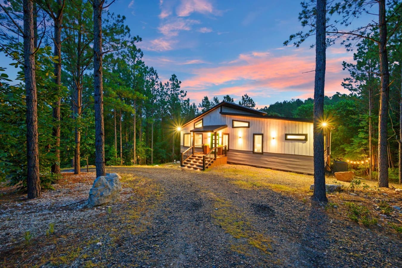This glowing cabin surrounded by towering pines is basically your own little sanctuary in the woods—no cell service required.