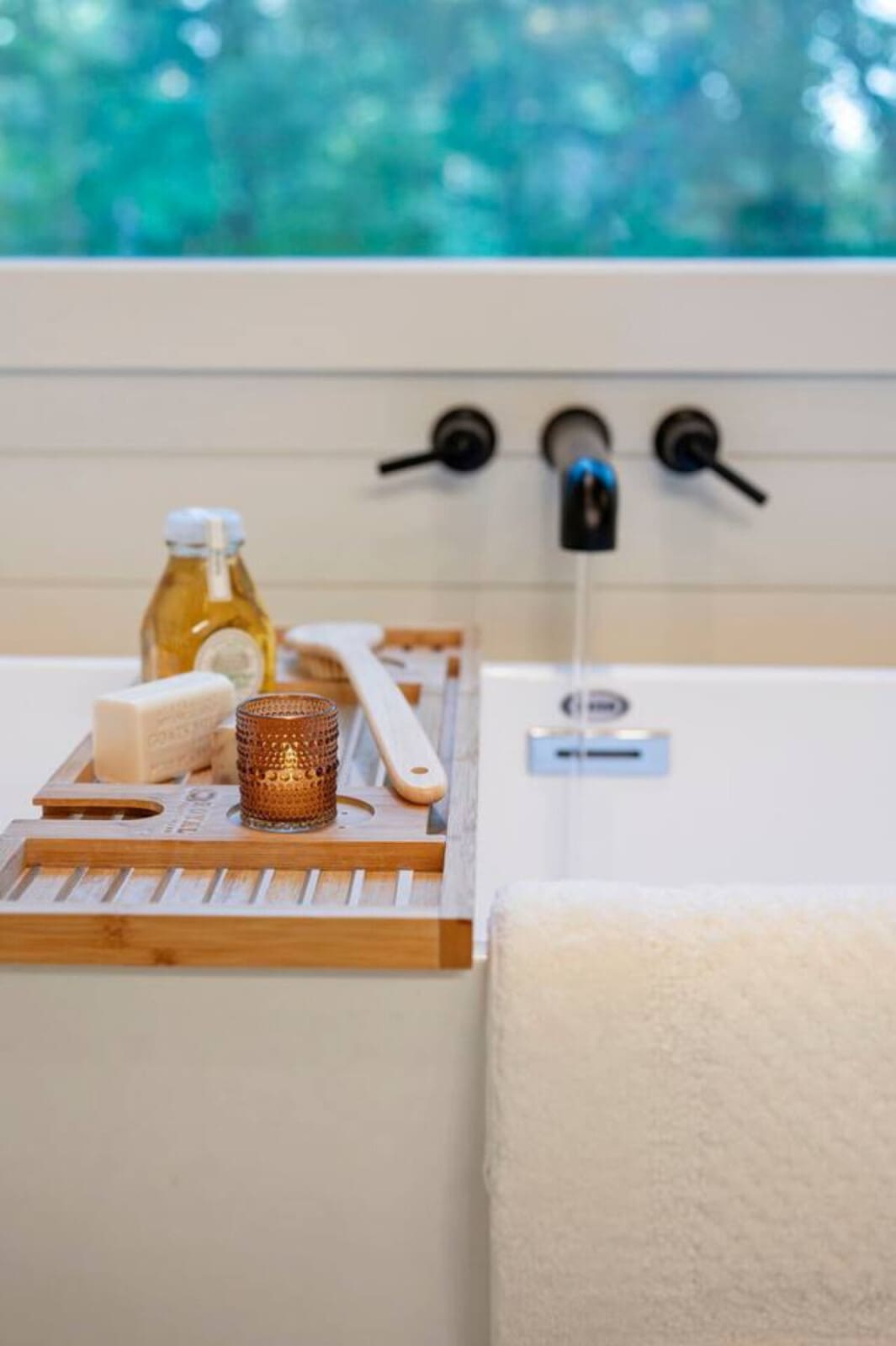 The bathroom setup on this deck is basically spa goals—you've got earbuds, natural light, and a view that makes you forget you're supposed to be doing anything other than just existing in this moment.