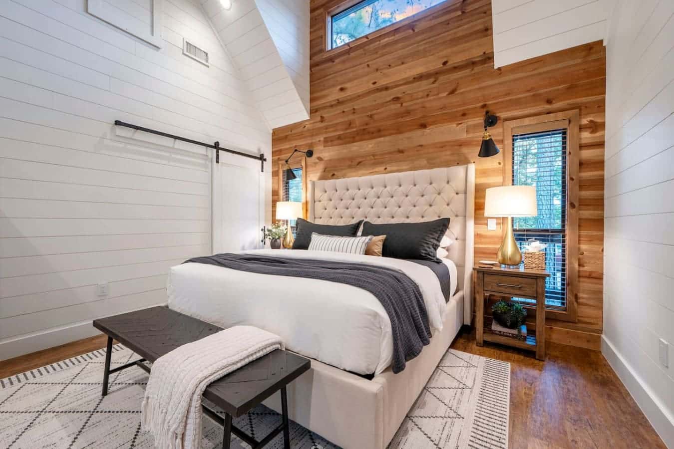 This bedroom is absolutely gorgeous with those wood walls and that dreamy tufted headboard—it's the kind of space where you actually want to spend time relaxing instead of just crashing at night.