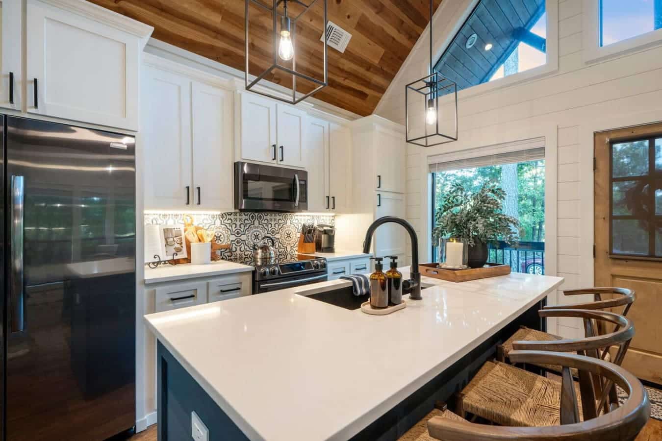 This kitchen is where you'll actually want to spend time cooking with those soaring ceilings, natural light flooding in, and a layout that somehow manages to be both totally functional and seriously gorgeous.