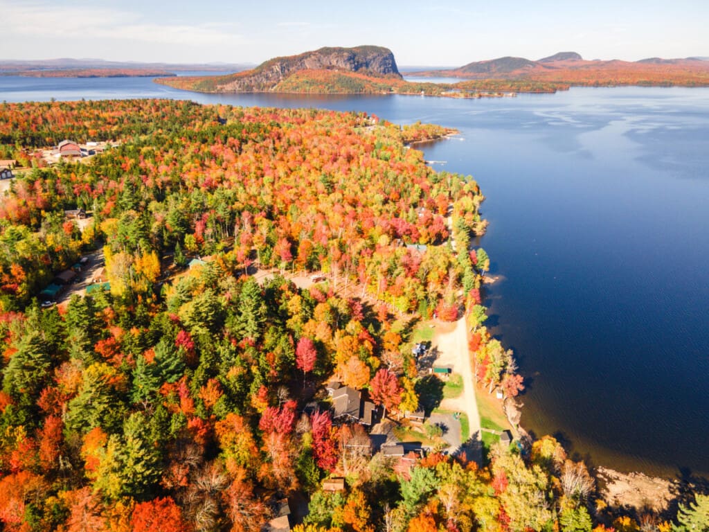 Cabins tucked between the trees and the lake’s gentle waves.