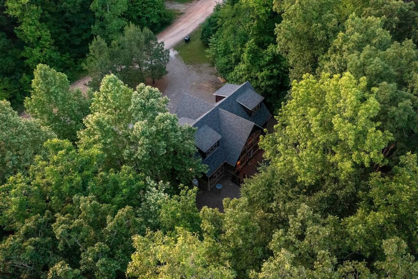 A soaring view of our rustic cabin nestled in wooded splendor.