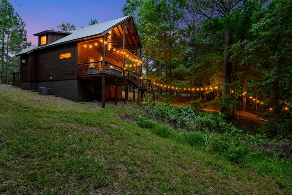 String lights dance among the giants, casting a spell over our cabin retreat.