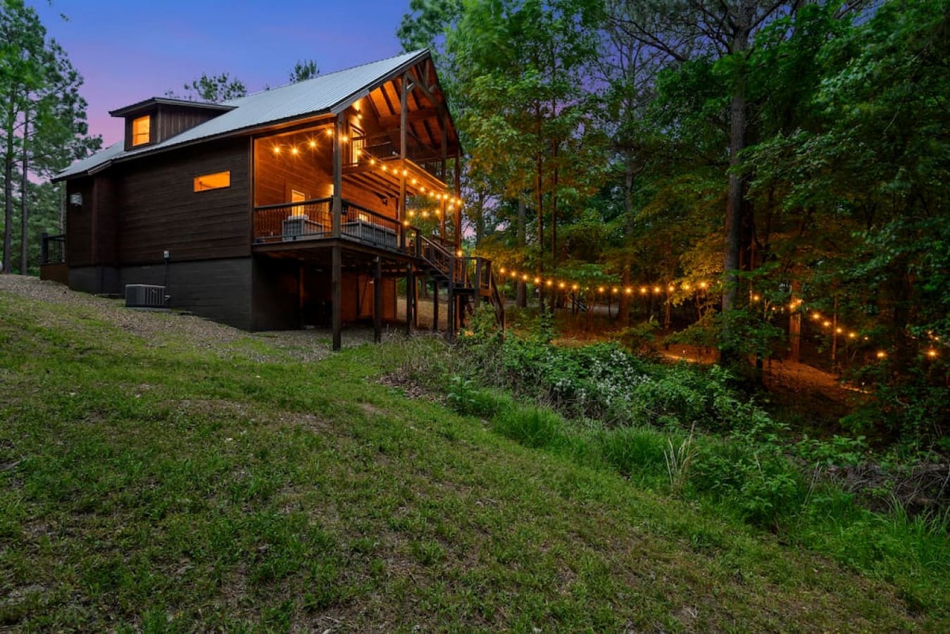 String lights dance among the giants, casting a spell over our cabin retreat.