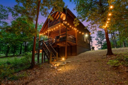 Underneath a canopy of stars and tall trees, our cabin glows with magic.