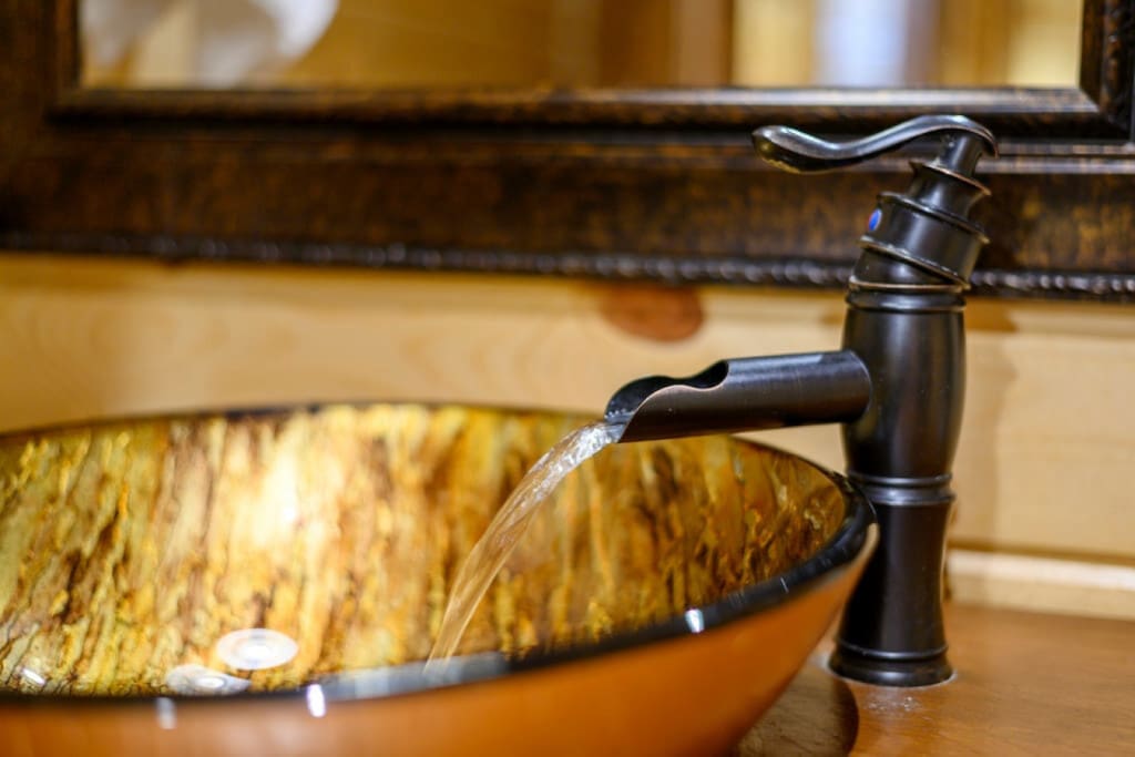Crafted elegance: Our cabin's bathroom faucet brings sophistication to rustic charm.