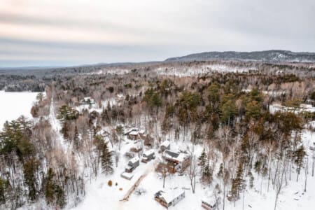 Wake up to snow-covered forests and mountains in every direction—this is what a real Maine winter wonderland looks like from your cabin doorstep.