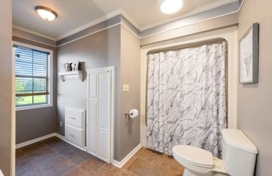 This spacious master bath has everything you need to start your day right, with plenty of natural light and a gorgeous marble shower to wash away the stress.