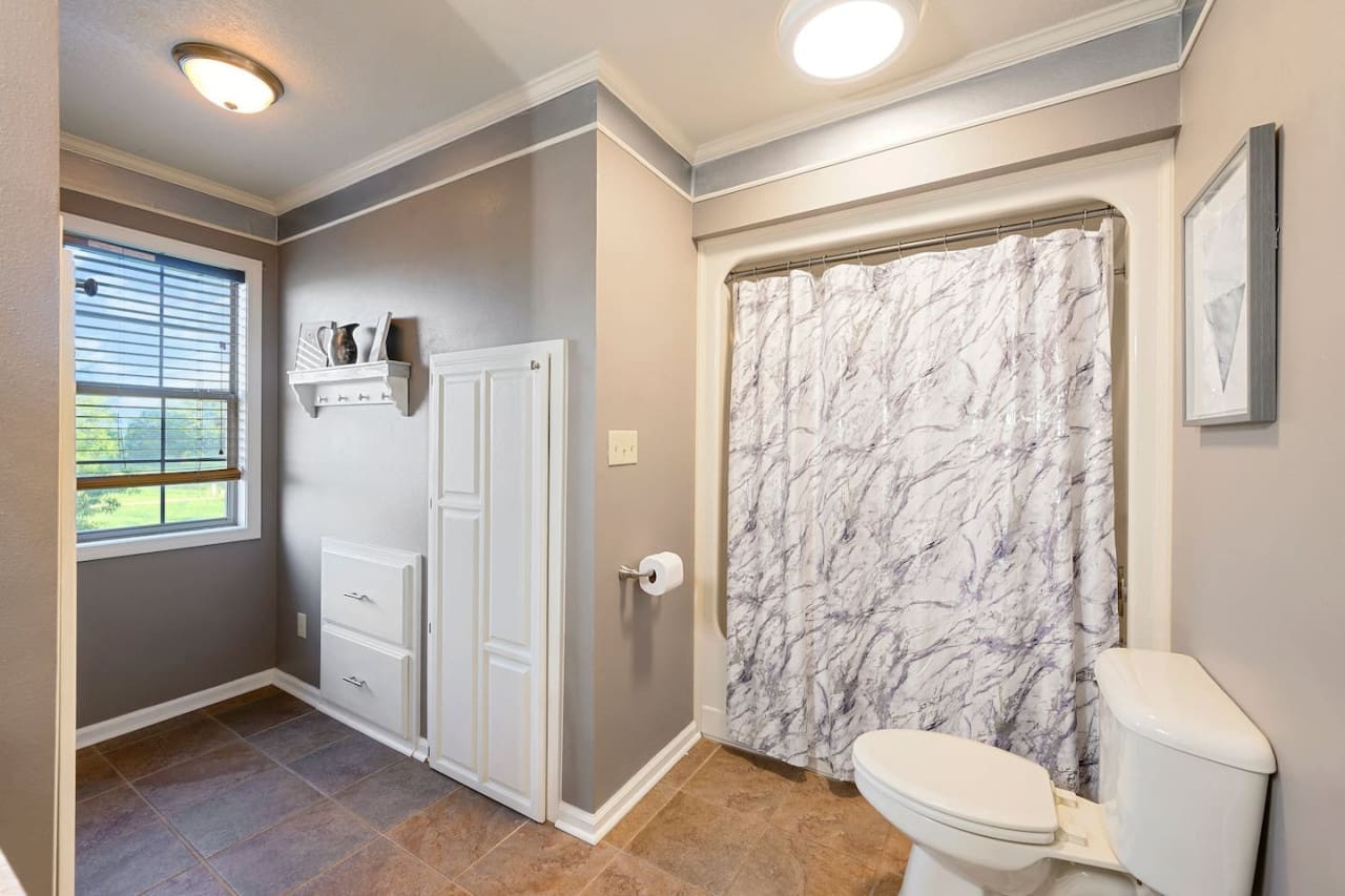 This spacious master bath has everything you need to start your day right, with plenty of natural light and a gorgeous marble shower to wash away the stress.