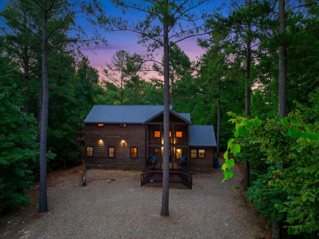 Embrace the serene beauty of nature with a picturesque front view of your cozy cabin.