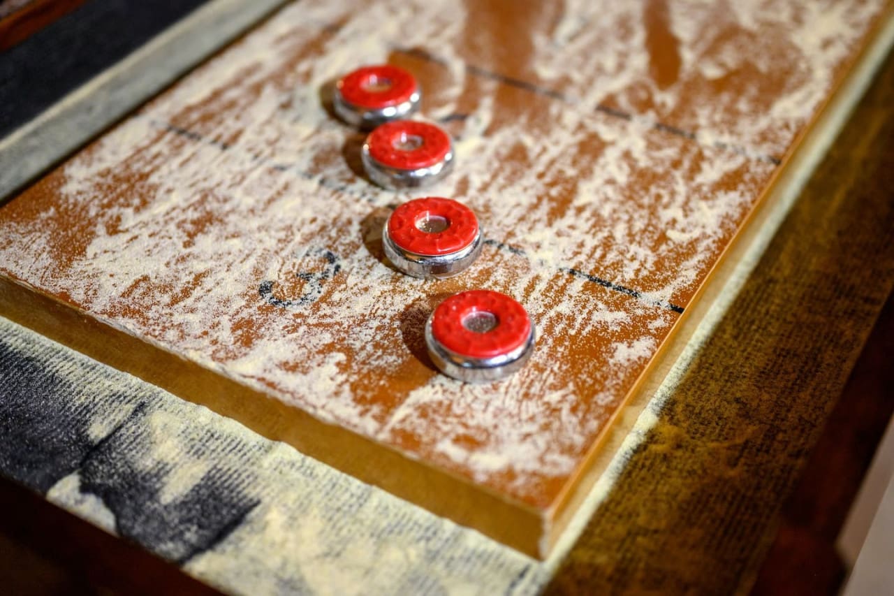 Turn game night into a winning experience with our sleek shuffleboard table—perfect for endless entertainment.