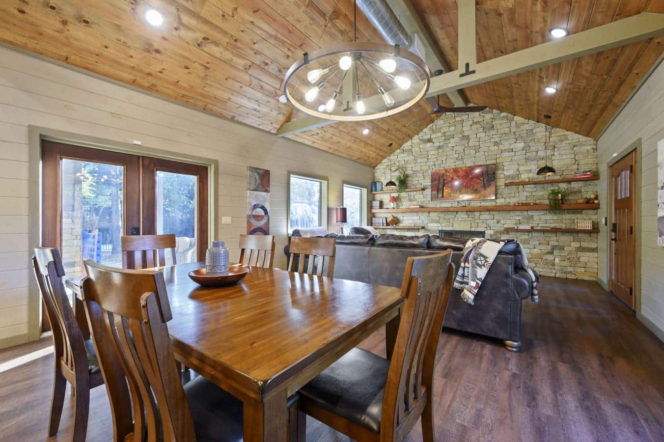 Cozy dining area with a stone fireplace and warm wood accents.