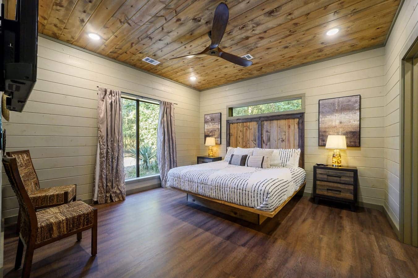 Spacious and inviting bedroom with natural light and modern-rustic decor.