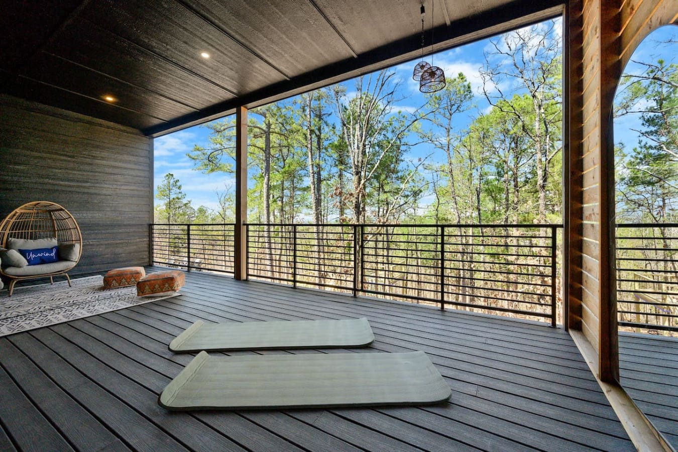 This covered deck is basically the ultimate wellness retreat—roll out your yoga mat, breathe in that forest air, and let those endless tree views be your meditation backdrop while you're suspended above it all.