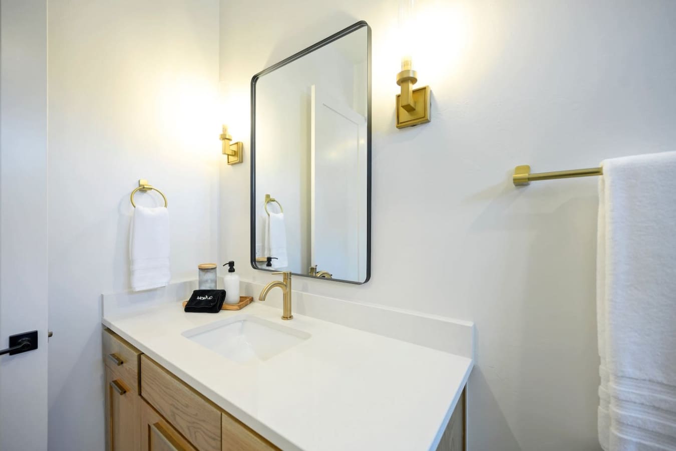 The brass fixtures and black-framed mirror in this bathroom basically make even your everyday routine feel like a little luxury spa moment.