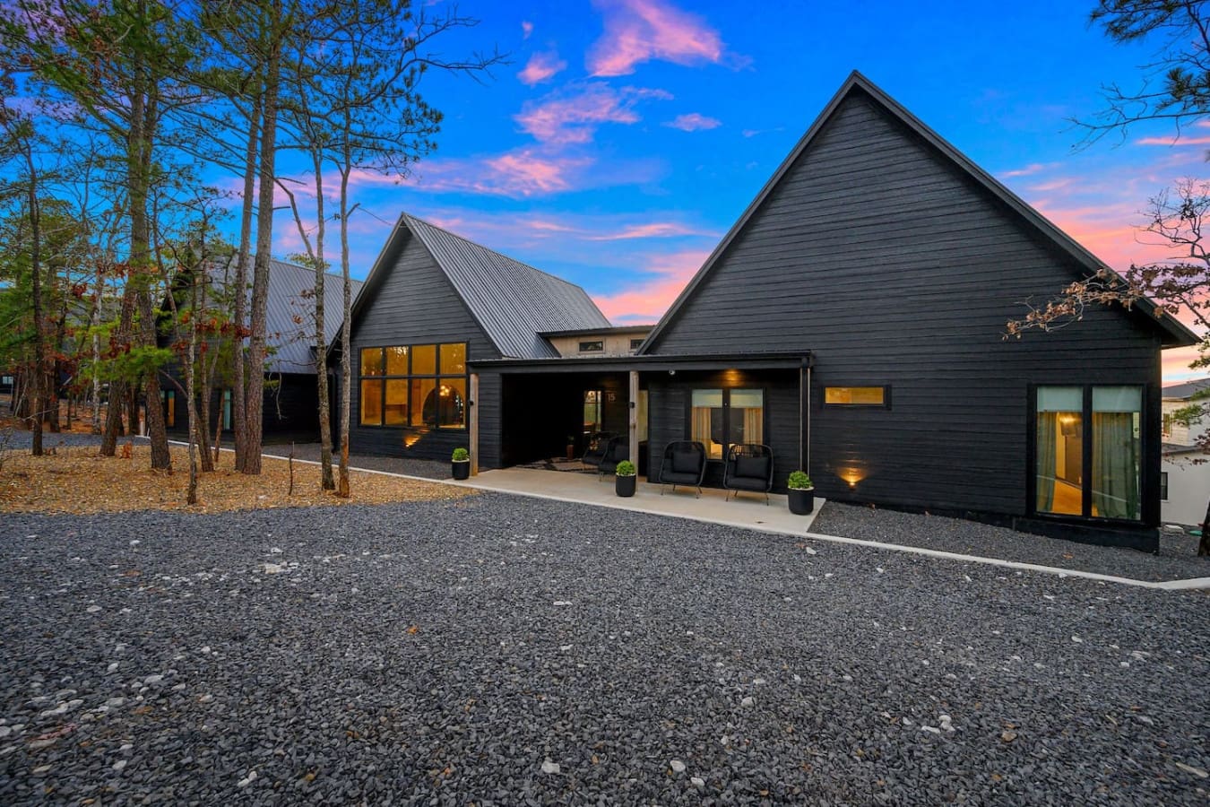 This stunning modern retreat tucked into the pines with those dramatic peaked roofs and moody black siding basically looks like the kind of architectural masterpiece where you get to watch the sky put on a show from your own private slice of forest sereni