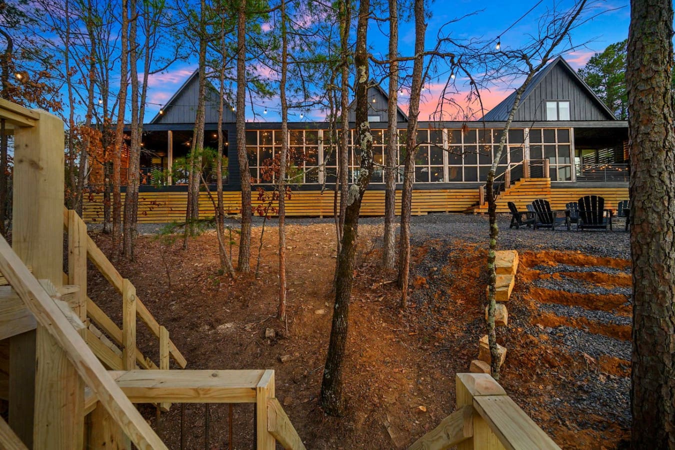 This modern timber retreat nestled among the tall pines with those dramatic peaked roofs basically looks like the perfect spot to watch the sunset paint the sky while you're surrounded by your own private slice of forest serenity.