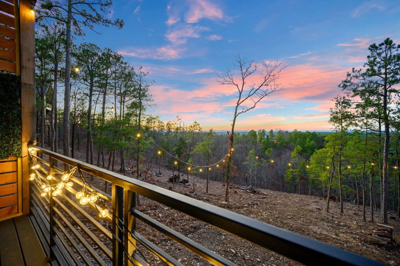Picture yourself on this deck at golden hour with twinkling lights strung overhead and that endless forest view stretching out before you—basically the kind of sunset moment that makes you forget your phone exists.