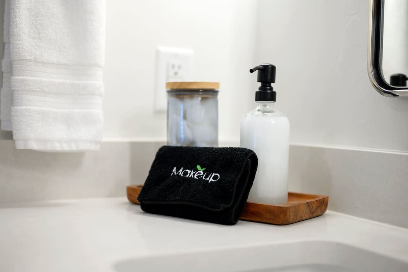 The bathroom counter is basically set up with all those thoughtful little touches—soft towels, a sleek soap dispenser, and a wooden tray—that make you feel like someone actually cared about the details.