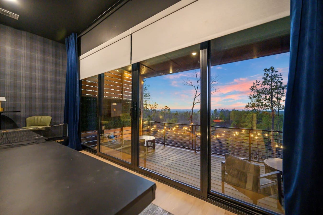 Watch the sky turn into a masterpiece of pinks and purples from your own private deck perched above an endless sea of pine trees, with twinkling lights and that perfect spot to settle in for the evening.