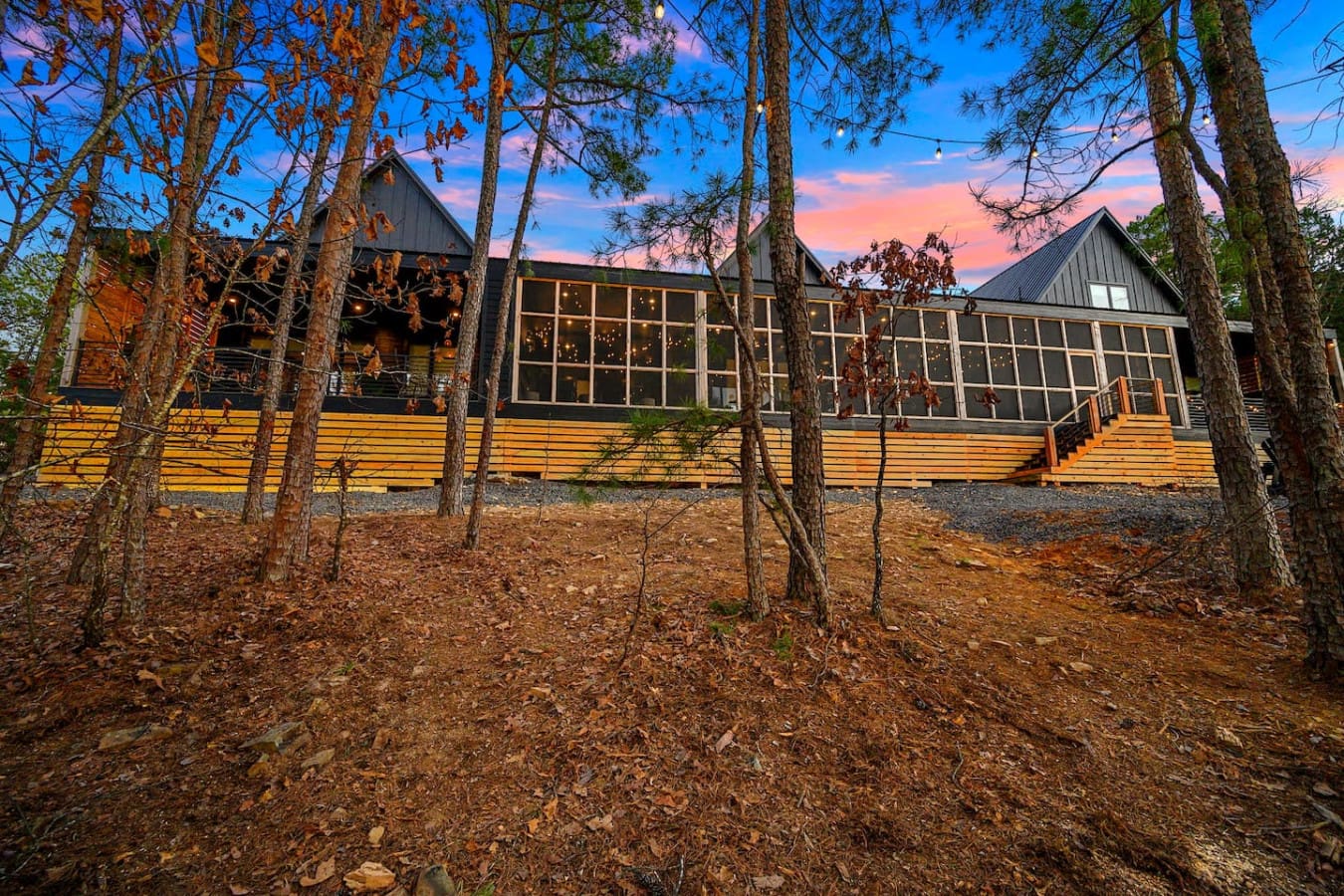 This modern timber retreat nestled in the pines with those dramatic peaked roofs and expansive windows basically looks like the kind of place where you can watch the sky turn into pure magic while feeling completely hidden away in your own forest sanctuar