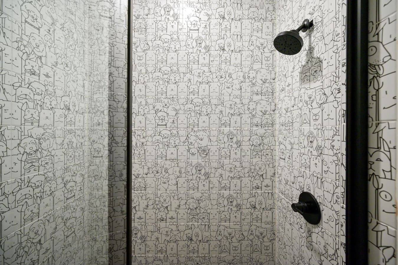 This shower is basically a work of art with every single tile covered in tiny illustrated faces—it's the kind of quirky, personality-packed design that'll have you grinning every time you step in to rinse off.