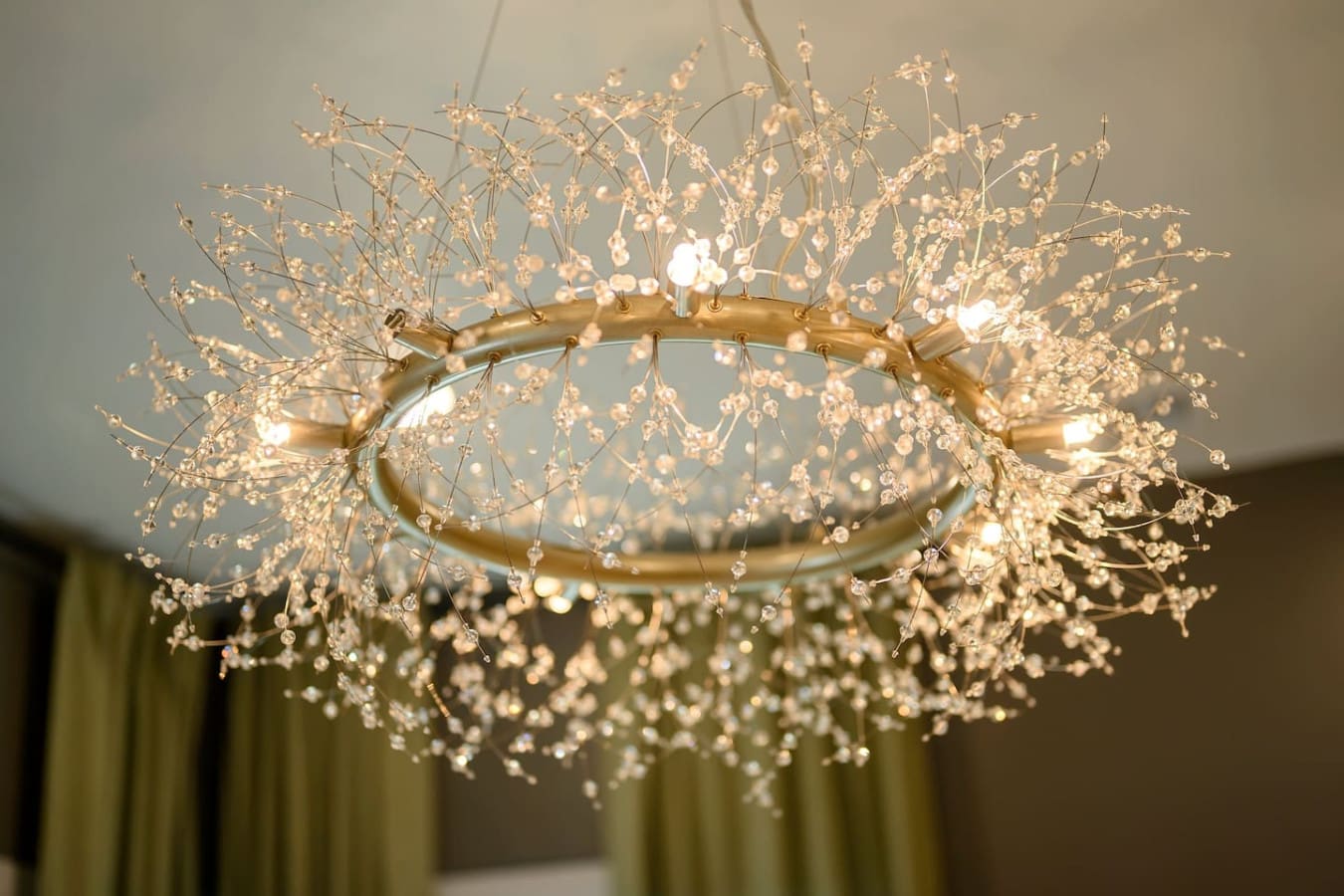 This absolutely stunning chandelier with its cascading crystal branches and warm glowing lights is basically like having a piece of jewelry hanging from your ceiling—it's the kind of show-stopping detail that makes you pause and just stare every time you