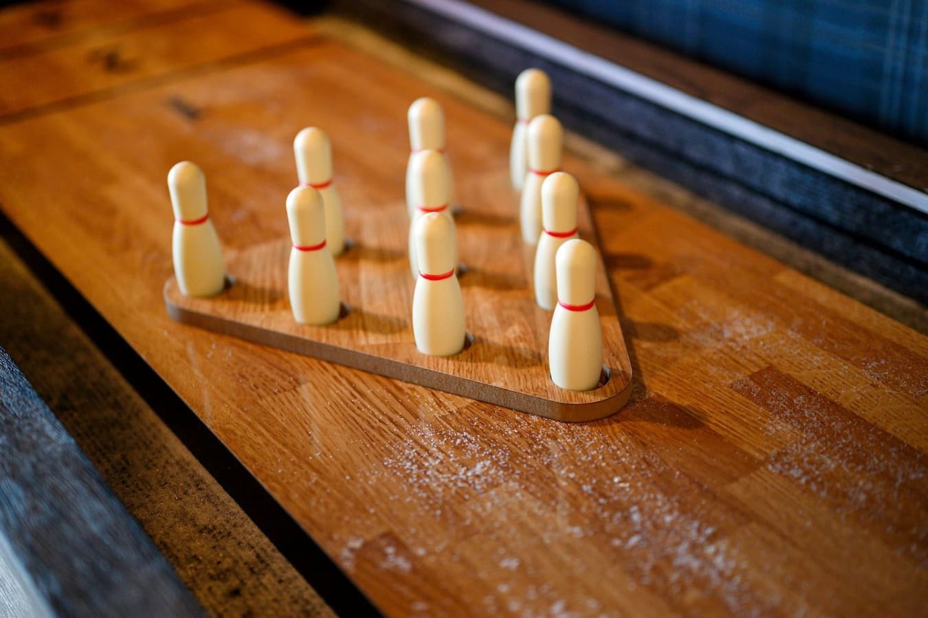 These classic wooden bowling pins lined up on the lane basically have that satisfying retro vibe that makes you want to grab a ball and see if you've still got it.