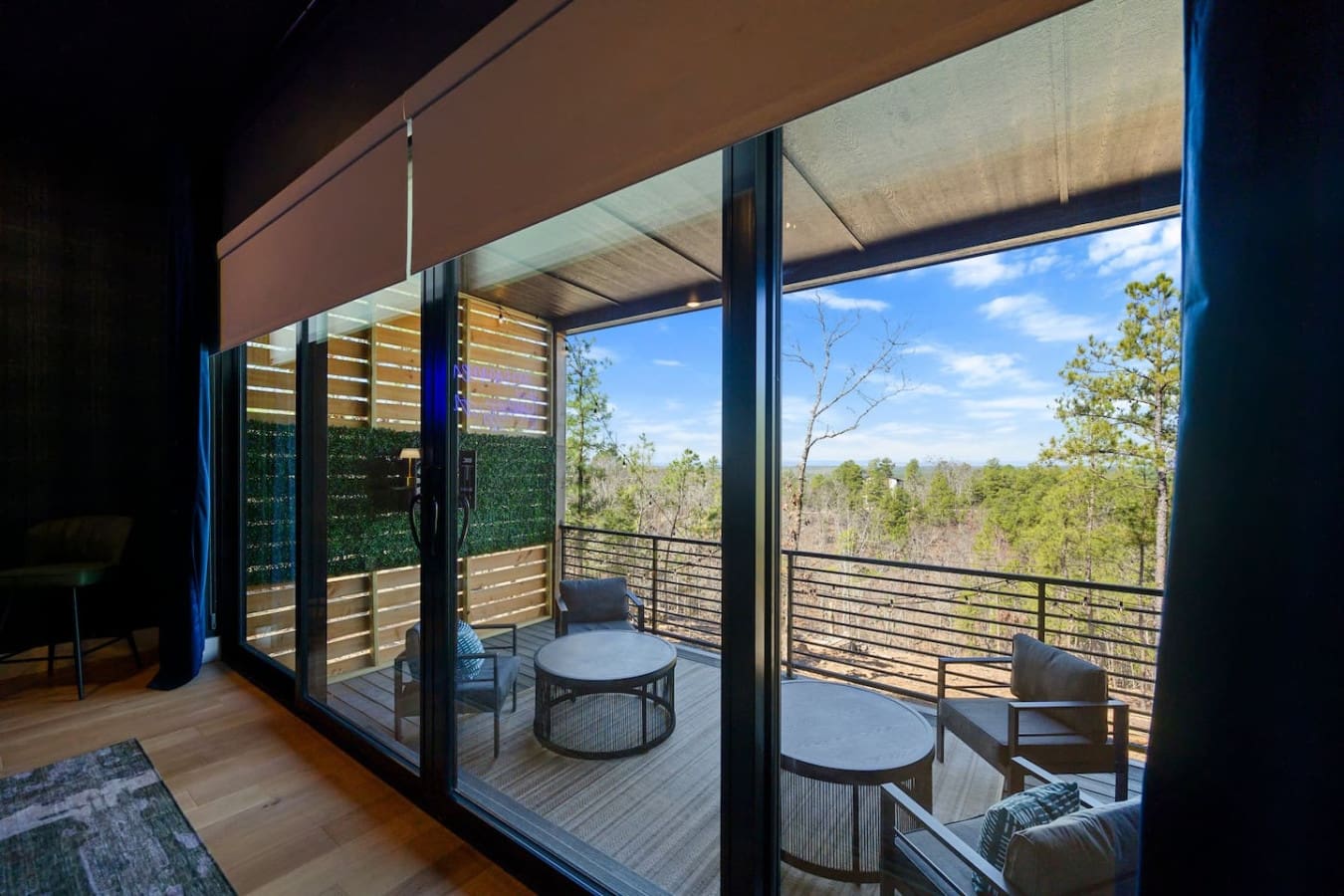 Stepping out onto this expansive deck with those sleek metal railings and panoramic forest views basically feels like you're floating above your own private slice of nature—the perfect spot to watch the day unfold while surrounded by endless green.