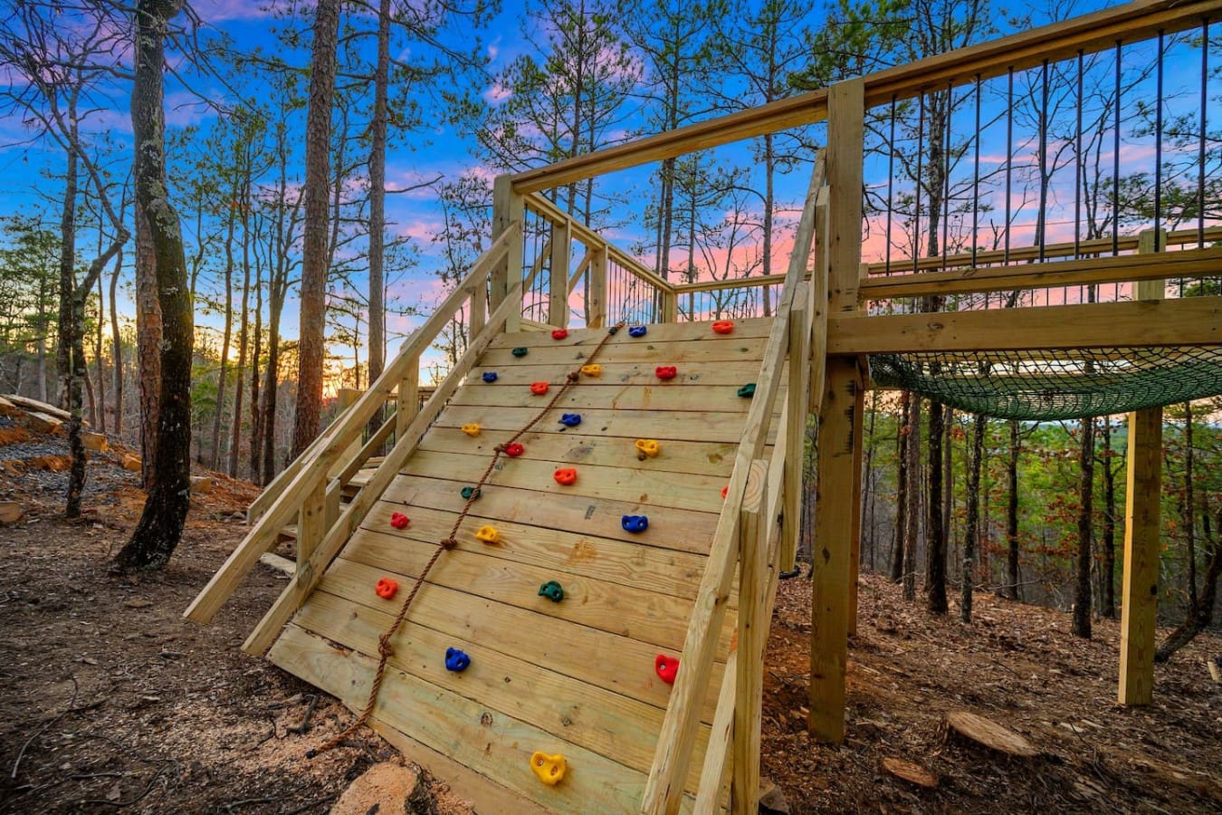 This climbing wall built right into the deck stairs is basically the perfect way to keep the kids entertained while you're watching the sunset and sipping your coffee—it's like having your own adventure playground in the backyard.