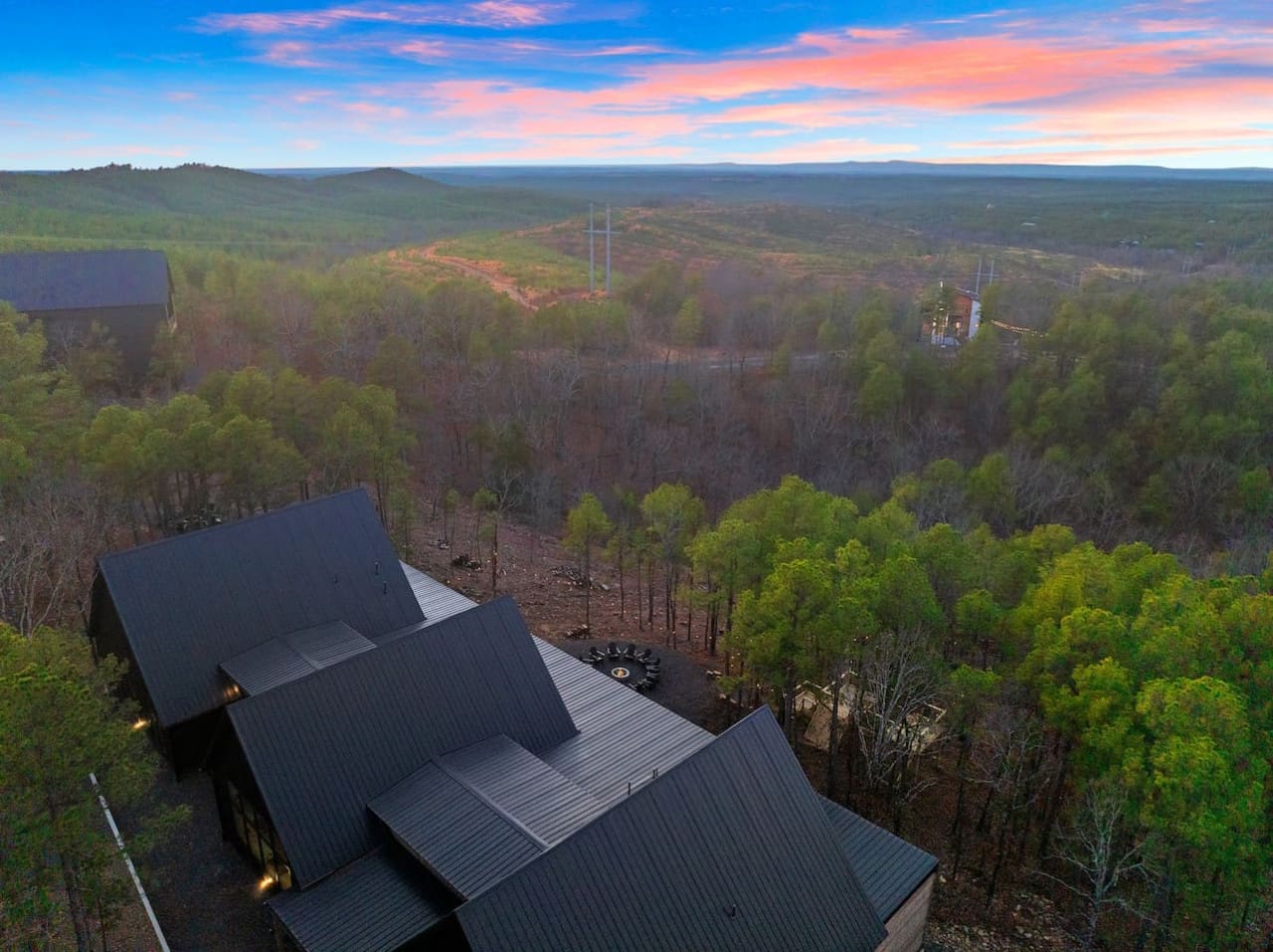 Watch the sunset paint the sky in shades of pink and gold while perched on your own private deck overlooking a sprawling forest that stretches all the way to the horizon—this is basically peak escape energy.