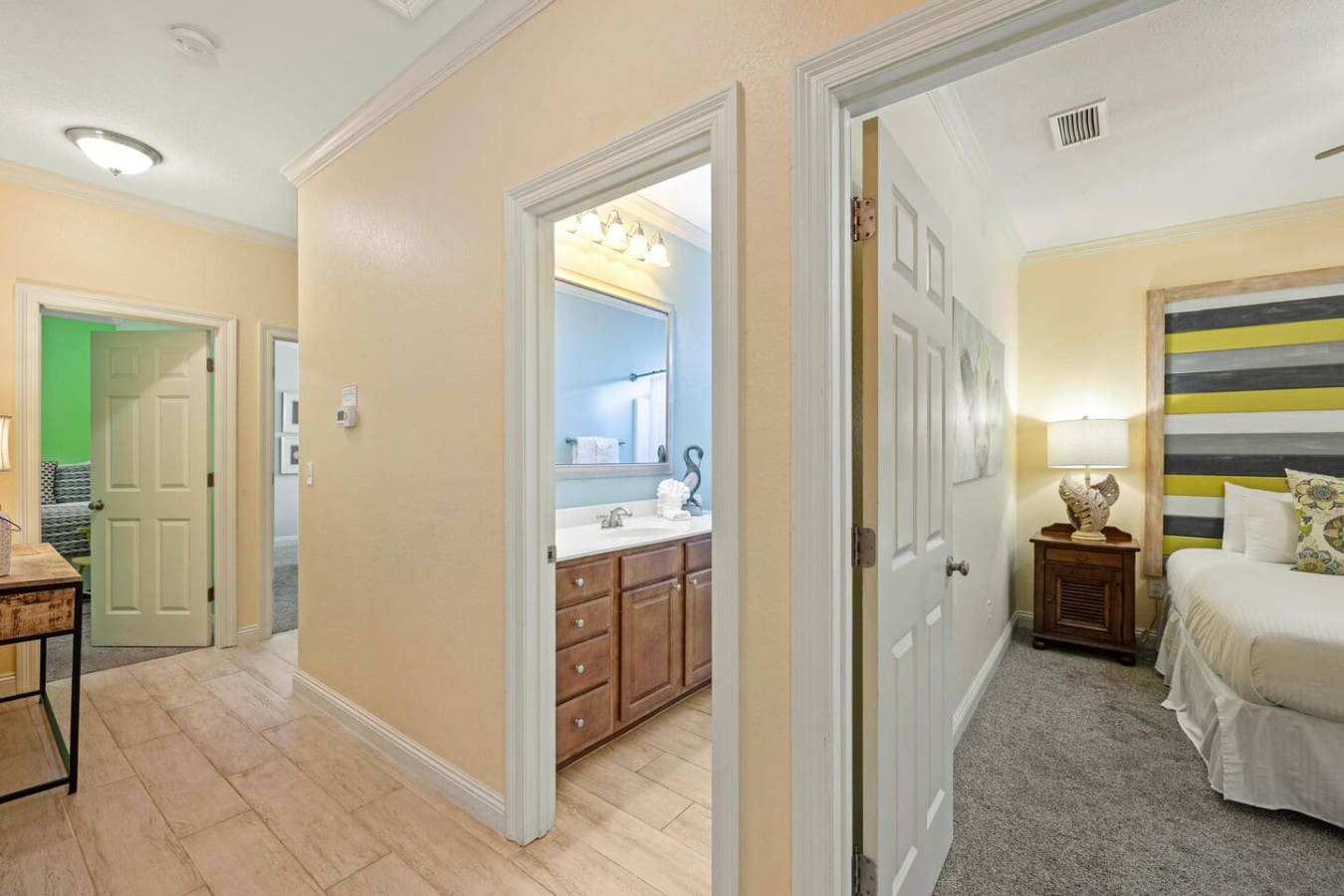 This hallway is basically your personal corridor to pure convenience—bathroom, bedrooms, and closets all within arm's reach, proving that sometimes the best vacation details are the practical ones.