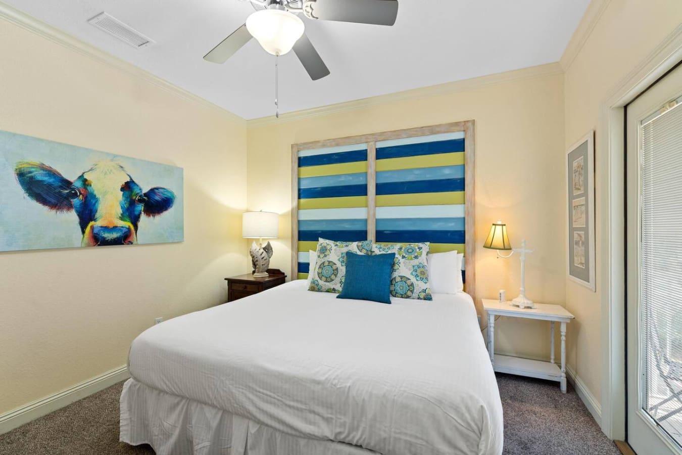 Wake up in this cheerful bedroom where that bold striped headboard instantly puts you in vacation mode, and those coordinating pillows basically scream "sleep in, you're on island time now."