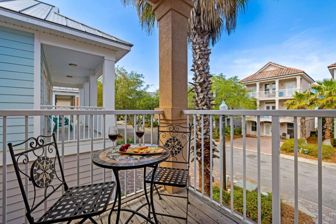 This second-floor balcony wraps around a massive palm tree like nature's own centerpiece, giving you the perfect perch to watch the world go by while you're basically living in your own treehouse.