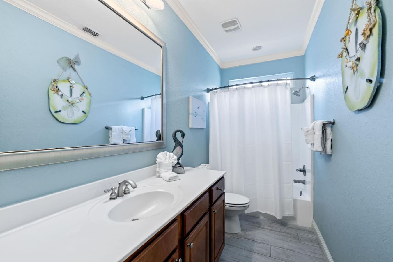 This spa-like bathroom with its dreamy turquoise walls and clean white finishes is basically the perfect spot to rinse off the sand and get ready for round two of your beach day adventures.