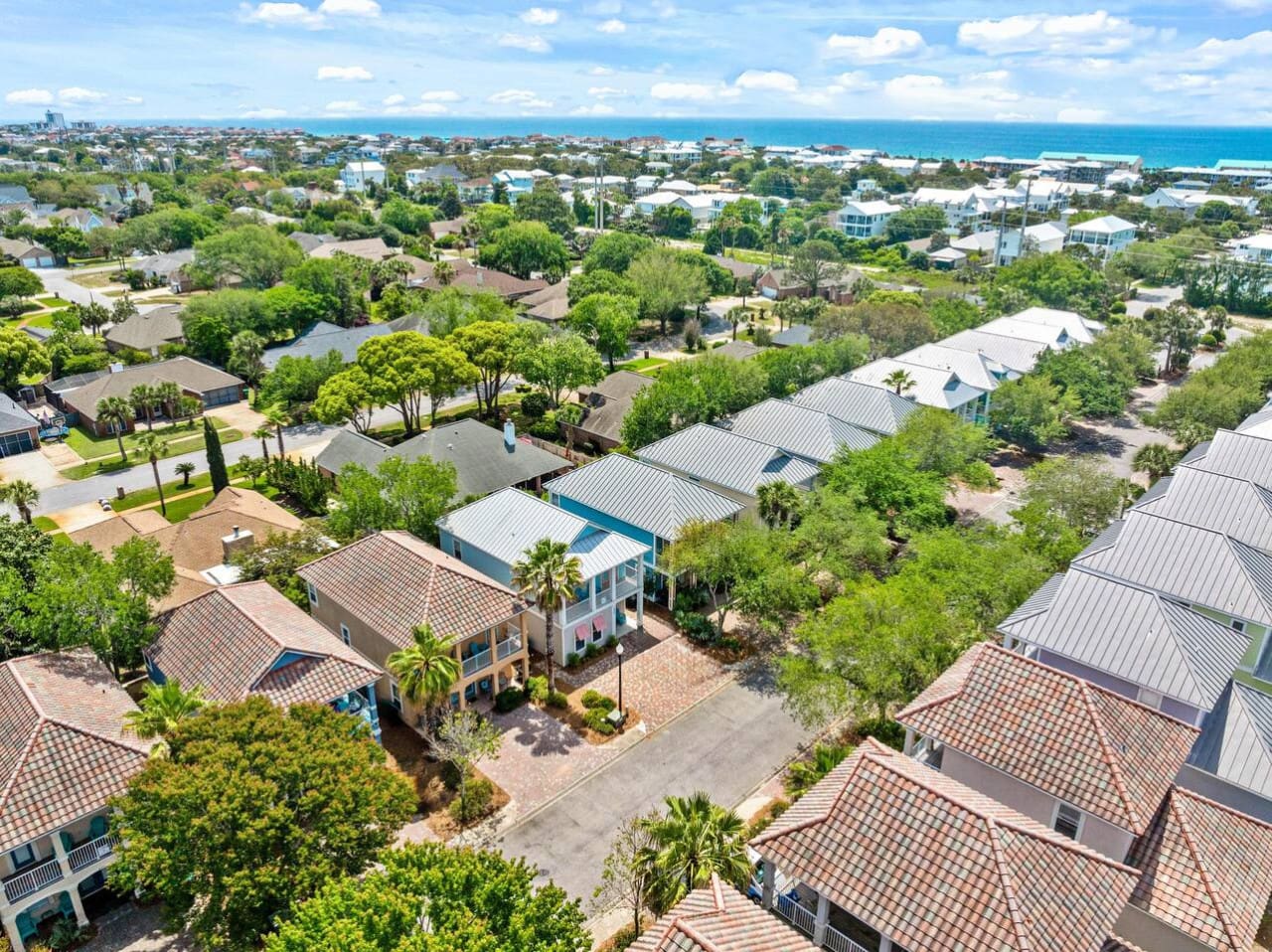 This neighborhood aerial view is basically the ultimate proof that you scored a spot close enough to hear the waves but with enough green space and resort vibes to feel like you've got your own private slice of paradise.