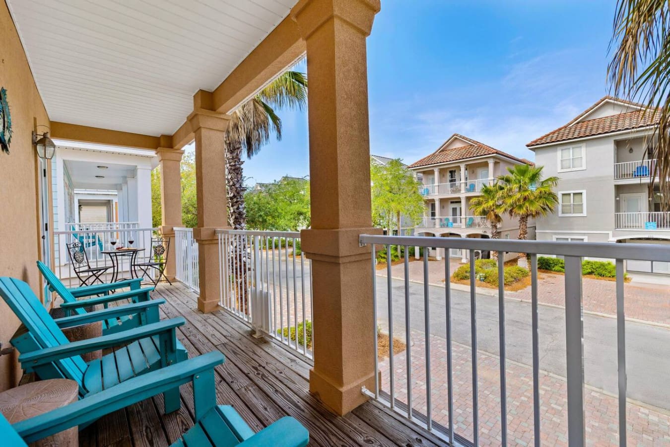 Kick back in your own private retreat with those turquoise Adirondack chairs waiting to cradle you while you watch the palm trees sway and the neighborhood buzz below.