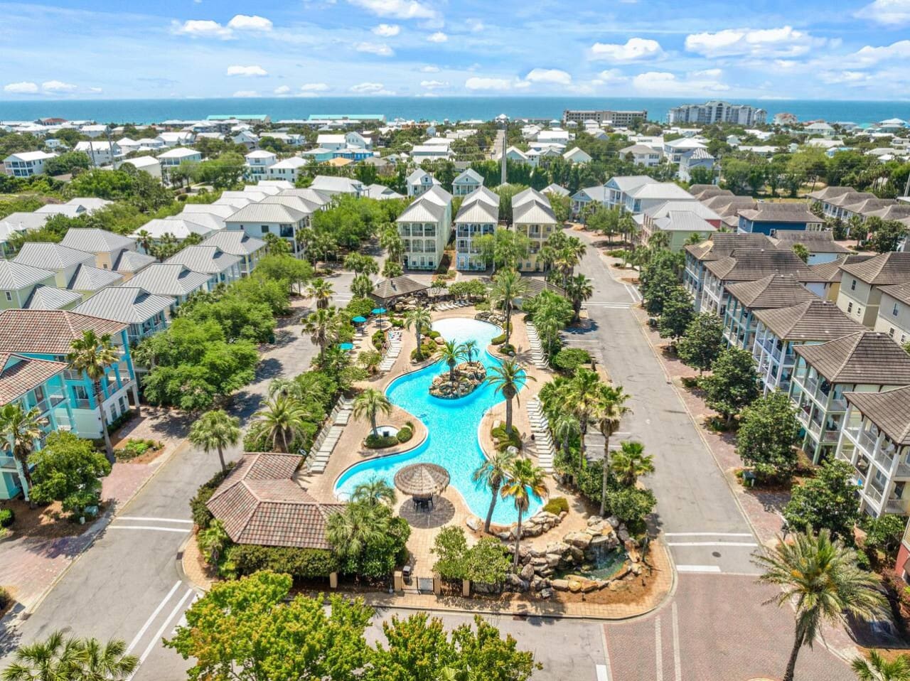 From your front porch, you can literally see the ocean peeking over the rooftops while the resort pools and palm trees create this perfect bubble of pure relaxation right in your own backyard.