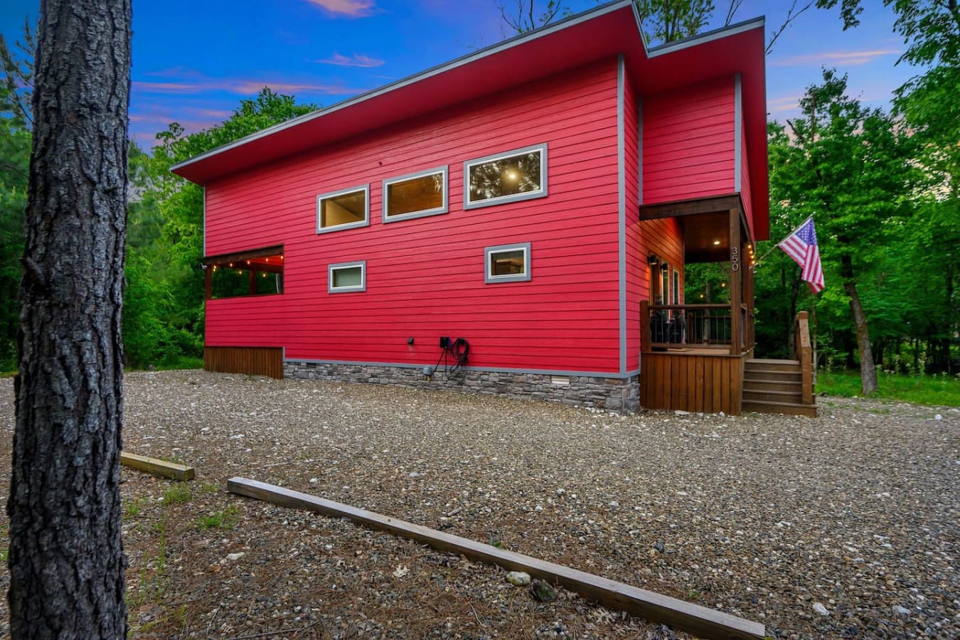 This is the kind of view that makes you realize why people build cabins in the middle of nowhere—your own little red sanctuary surrounded by nothing but trees, sky, and the promise of some serious peace and quiet.