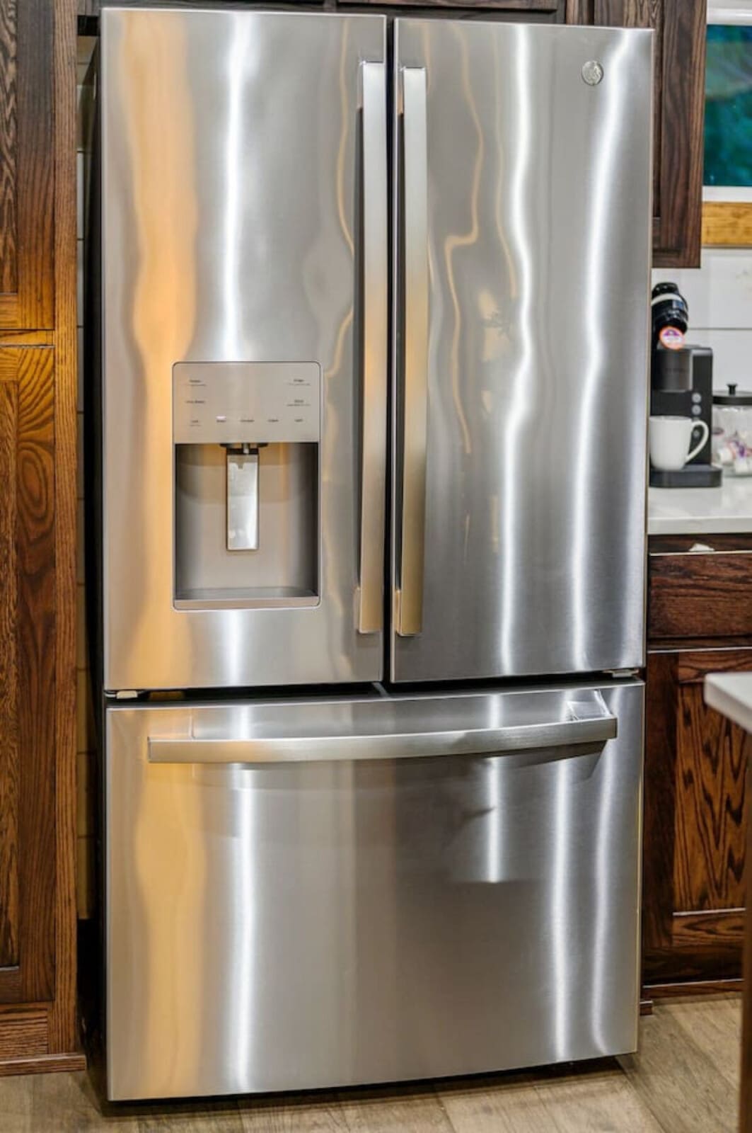 This stainless steel French-door fridge with the built-in ice and water dispenser is basically your kitchen's best friend—no more trips to the store for ice, and everything stays perfectly chilled for whatever you're cooking up during your stay.