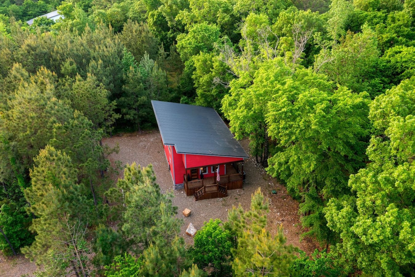 Nestled deep in the trees with that unmistakable red roof peeking through the canopy, Lil Red feels less like you're visiting a cabin and more like you've discovered your own secret hideaway in the woods.