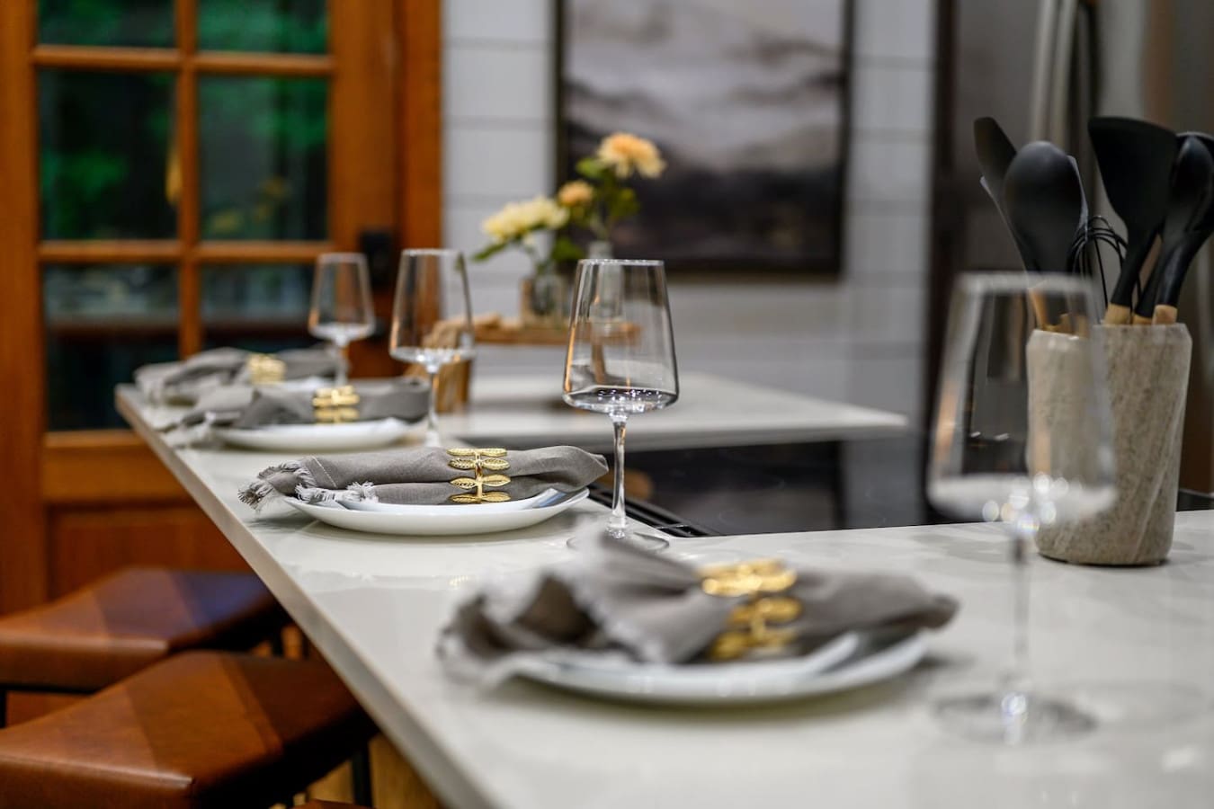 This dining setup—with its clean lines, thoughtful place settings, and those big windows framing the view—is basically designed for the kind of meals where conversation flows as naturally as the light pouring in.