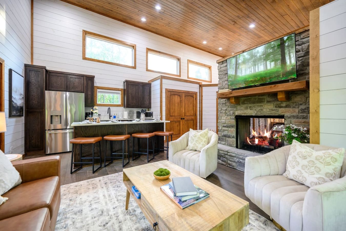 The kitchen island is basically the social command center of this cabin—pull up a stool and you've got prime real estate for watching the fire, chatting with your crew, and keeping tabs on whatever's happening in the living room.