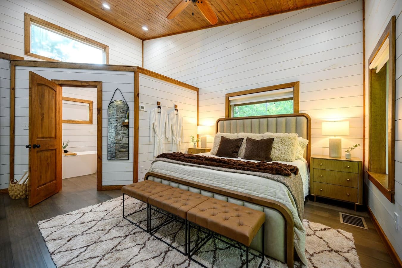The bedroom's got this perfect blend of that mid-century modern vibe and mountain lodge coziness that somehow makes you want to both sleep for 12 hours and never leave the bed.