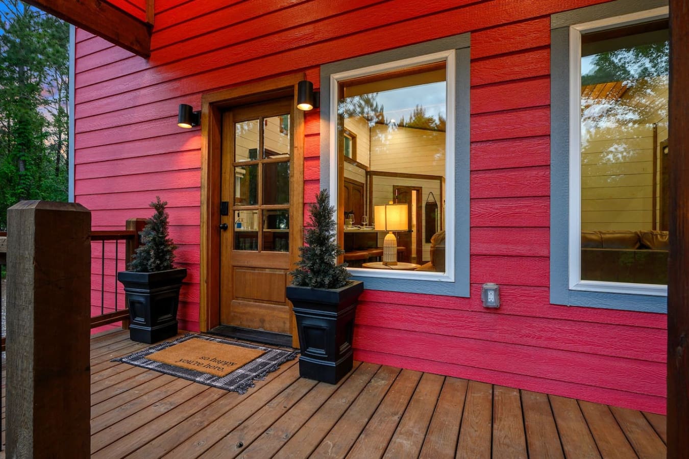 The warm glow spilling out onto this front porch at twilight is basically the cabin saying "come on in, we've got stories to tell tonight."