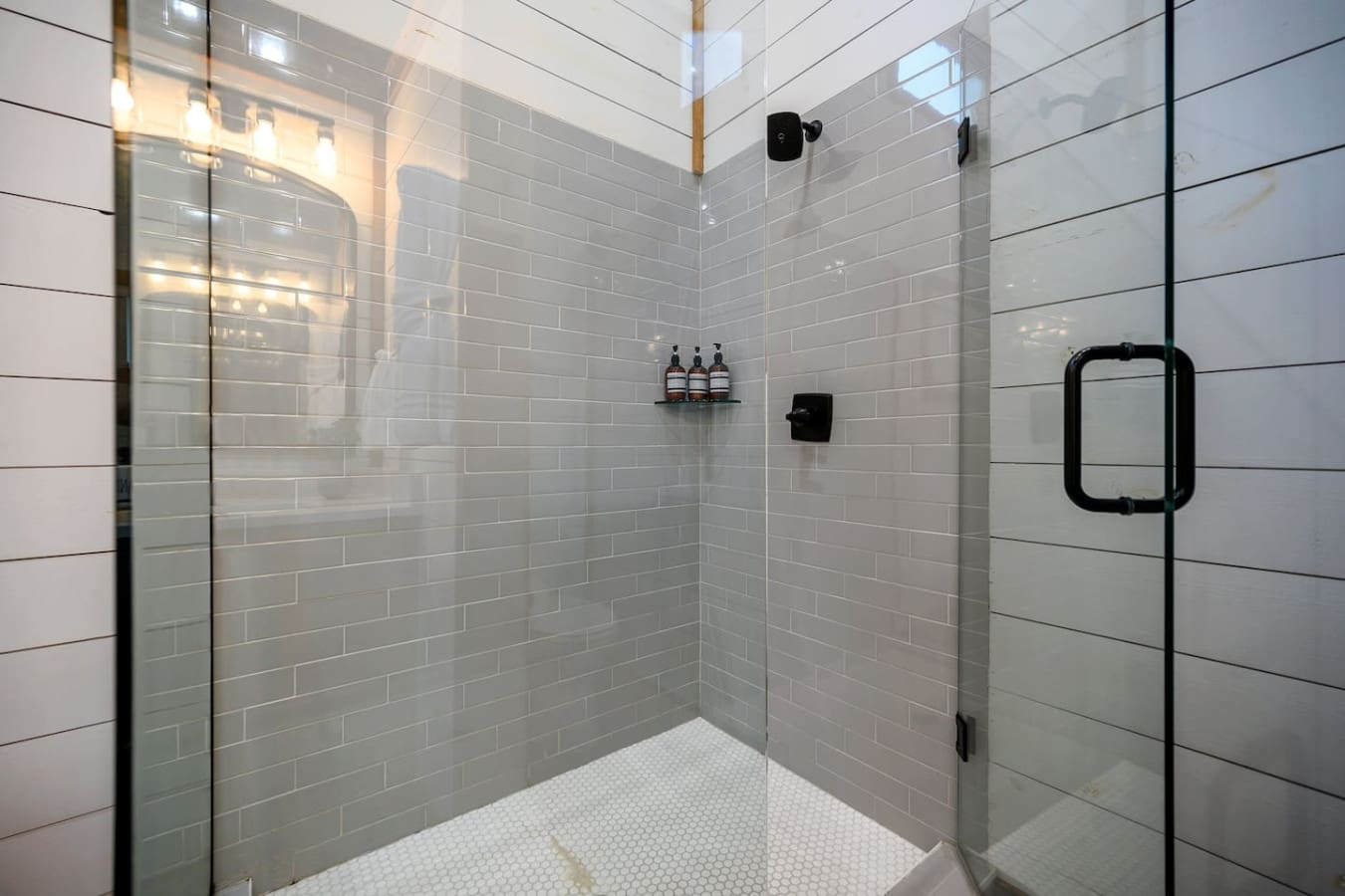 This walk-in shower is basically a no-fuss sanctuary where you can rinse off the day without any drama, complete with black fixtures that keep things looking sharp and clean.