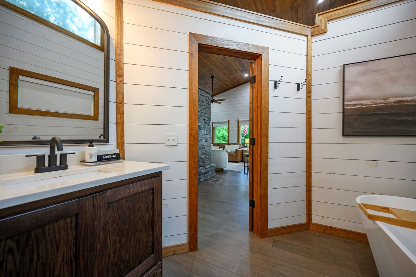 This primary bathroom hits that perfect sweet spot where you get all the spa vibes (hello, soaking tub and spacious shower) wrapped up in honest-to-goodness rustic charm, and somehow it all just works together.