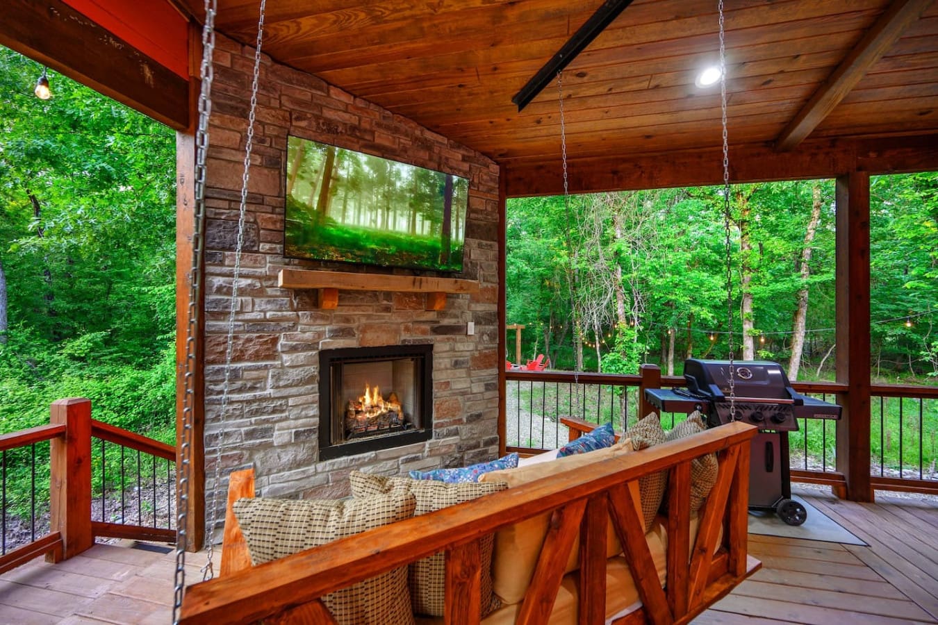 This brick fireplace turns your covered deck into the kind of gathering spot where you'll want to spend every evening—flames crackling, forest air mixing with that cozy warmth, and honestly, you might never actually leave.