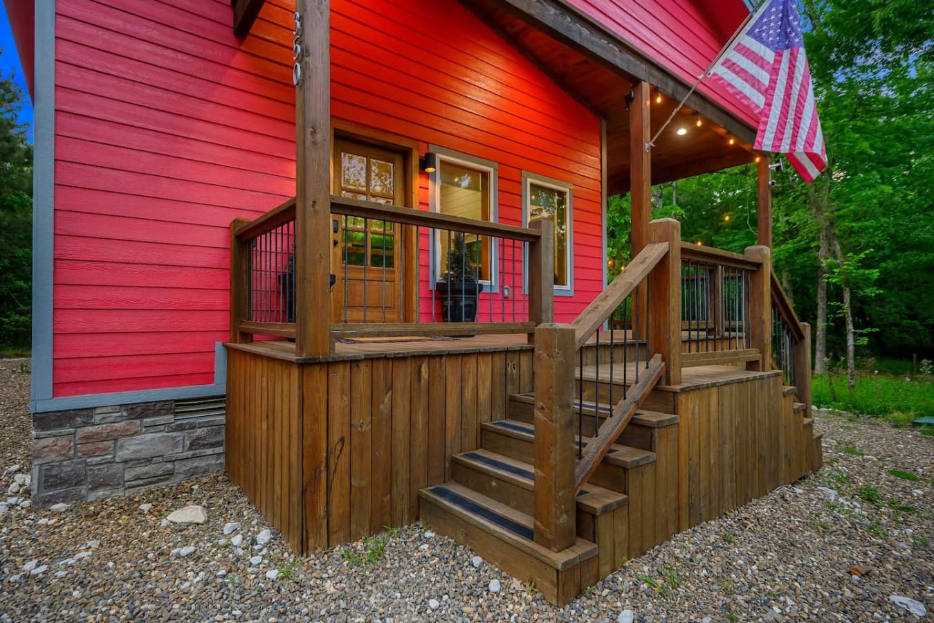 Welcome home to this charming front entrance where rustic wood railings and those signature red walls set the tone for the cozy, character-filled retreat waiting inside.